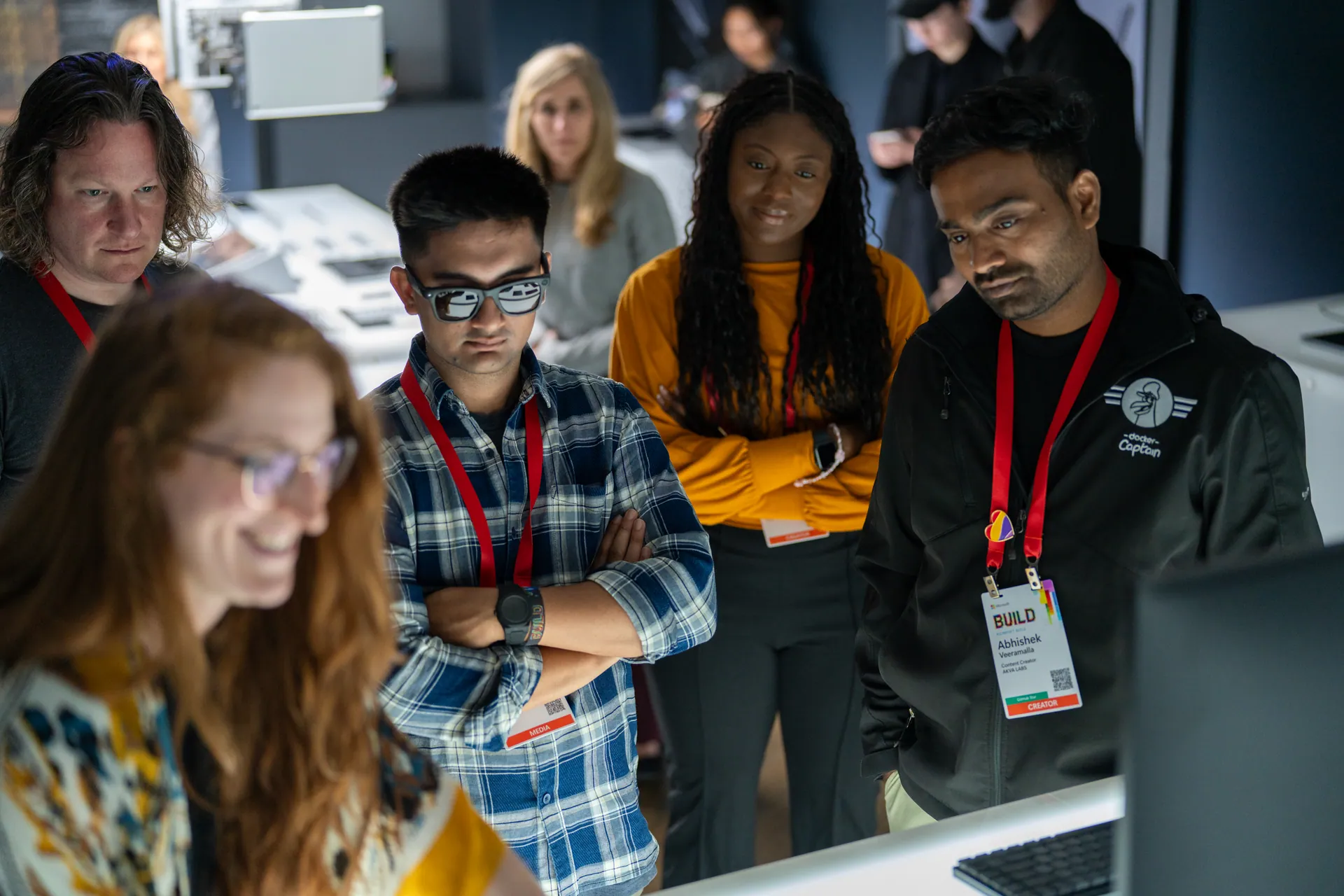 Attendees gathered around a lit product plinth at a Cadence 3 activation.